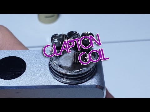 Zbliżenie na tradycyjną grzałkę spiralną (spiral coil) wykonaną z metalowego drutu oporowego, z widoczną bawełną w środku.